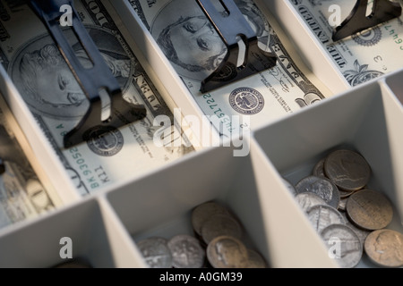 U S bills and coins in cash register Stock Photo