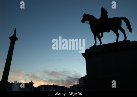 Statue of King George IV on horseback and Nelson's Column in silhouette, Trafalgar Square London UK Stock Photo