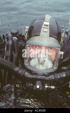 Military EOD diver wearing full face mask with built in communications and using a rebreather Stock Photo