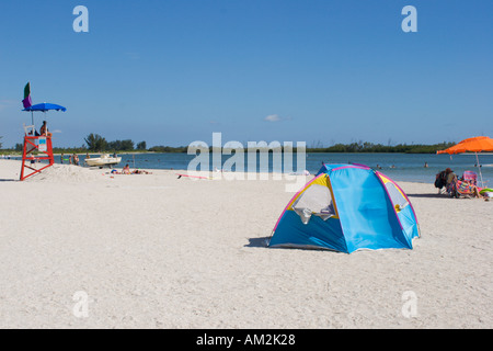 Wind blows tent on swimming beach at Ft De Soto Park in Florida USA Stock Photo