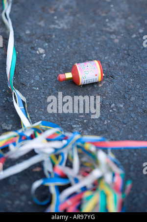 Used 'Party popper' in the road the day after a party Stock Photo