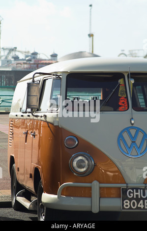 An orange and white Volkswagen VW type 2 split camper van. Stock Photo