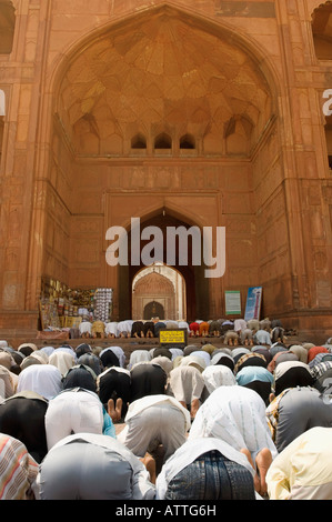 Rear view of a group of people praying in a mosque Stock Photo