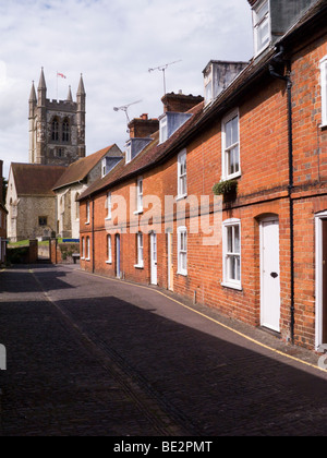 Row of Victorian terraced houses / cottages in front of St Andrew's Parish Church. Farnham. Surrey. UK. Stock Photo