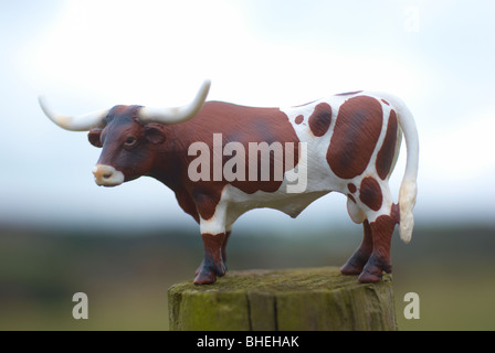 Texas longhorn plastic model cow photographed outside in a field. Stock Photo