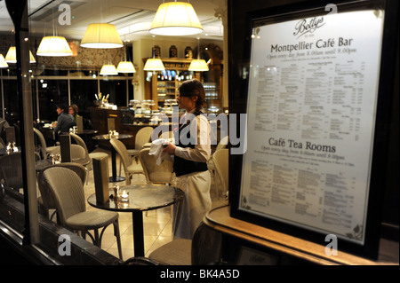 A member of staff looking out the window of Bettys Cafe and Tea Rooms in Harrogate Yorkshire UK Stock Photo