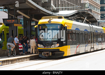 Passengers in downtown Minneapolis board a light rail passenger train destined for the Mall of America. Stock Photo