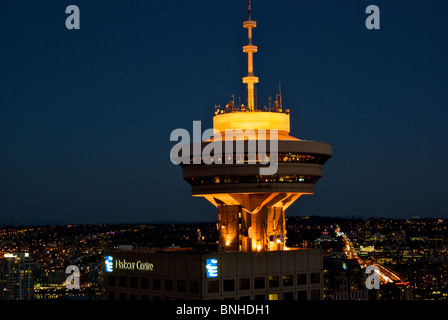 Harbour CentreTower revolving restaurant and illuminated streets neighbourhoods of Vancouver at night Stock Photo