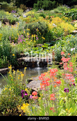 Pretty garden scene with flowers and a pond, Surrey England UK Stock Photo