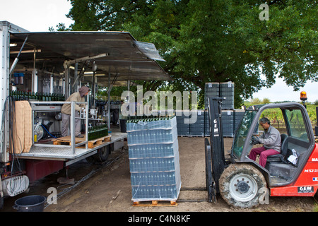 Wine bottling truck with mobile bottling line at Chateau Fontcaille Bellevue vineyard in Bordeaux region of France Stock Photo