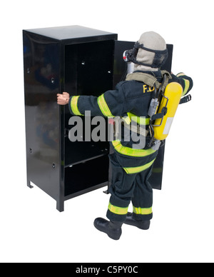 Fireman in front of a locker in protective gear used for fighting fires and saving lives - path included Stock Photo