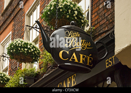 Little Bettys Cafe sign in the shape of a teapot hanging outside their cafe in Stonegate. Stock Photo