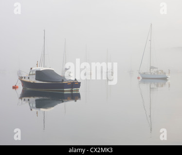 Boats in the mist on Kingsbridge Estuary, Salcombe, South Hams, Devon, England. Autumn (September) 2010. Stock Photo