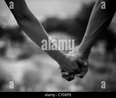 Adults holding hands Stock Photo