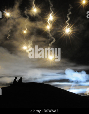 US Army soldiers watch flares light up the night sky during training October 1, 2012 at Fort Lee, Virginia. Stock Photo