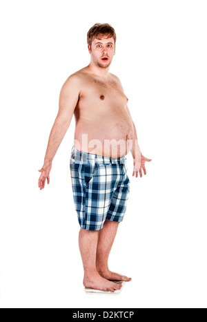 Overweight, fat man weighing himself on scales. Stock Photo