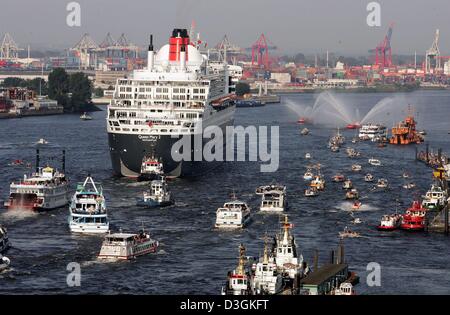 (dpa) - Trailed by several smaller boats leaves the world's largest and most expensive cruise ship, the Queen Mary 2, the harbour in Hamburg, Germany, Tuesday 20 July 2004. After spending a day in the northern German port city and impressing tens of thousands of onlookers, the ocean liner now heads to his home port of Southampton, United Kingdom. Stock Photo