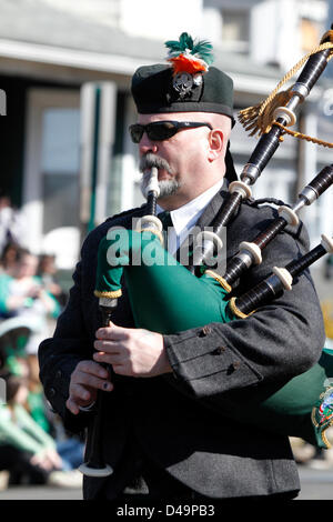 South Amboy, NJ, USA. 9th March, 2013. Bagpipe player marching in St. Patrick's Day Parade Stock Photo