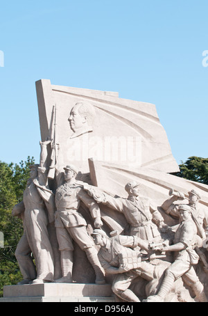 Stone revolutionary monument in front of Mausoleum of Mao Zedong at Tiananmen Square in Beijing, China Stock Photo