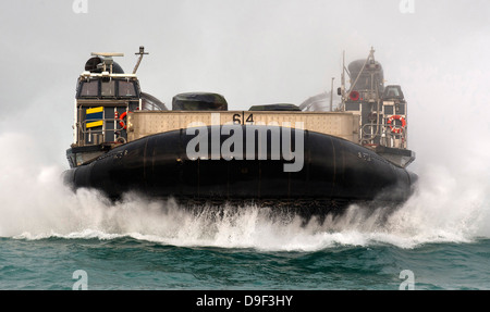 A landing craft air cushion approaches the well deck of USS New Orleans. Stock Photo