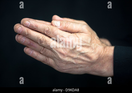 Old hands praying Stock Photo