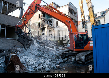 Demolition of an old building with heavy machinery for new construction Stock Photo