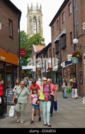 Tourists and shoppers stroll around Coppergate Walk in city centre of York North Yorkshire England UK Stock Photo