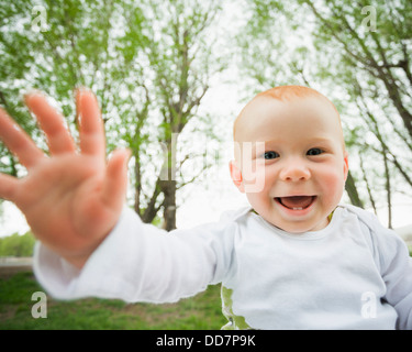 Caucasian baby laughing outdoors Stock Photo