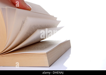 the book is scrolled by one hand Stock Photo