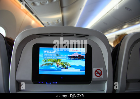 Interior of a Boeing 787 Dreamliner Thompson airways aircraft showing the individual passenger in flight entertainment screen Stock Photo