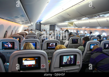 Interior of a Boeing 787 Dreamliner Thompson airways aircraft showing the individual passenger in flight entertainment screen Stock Photo