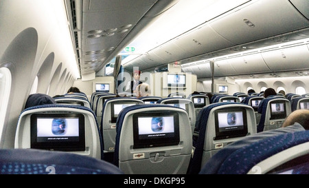 interior of Aeromexico Boeing 787 Dreamliner as Aeromexico flight attendant supervises showing of safety instructions video Stock Photo