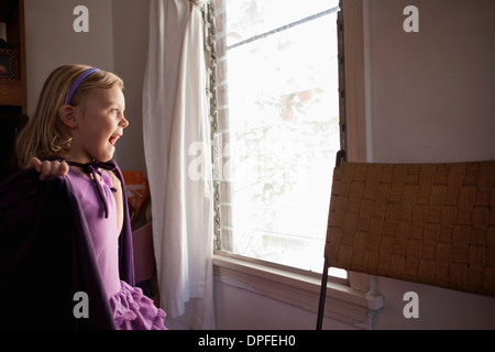 Portrait of young girl looking out of window Stock Photo