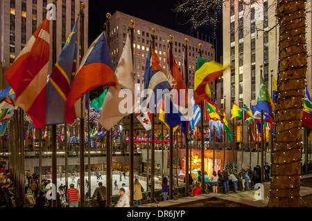 International flags surround the ice rink at Rockefeller Center, Manhattan, New York City, USA Stock Photo