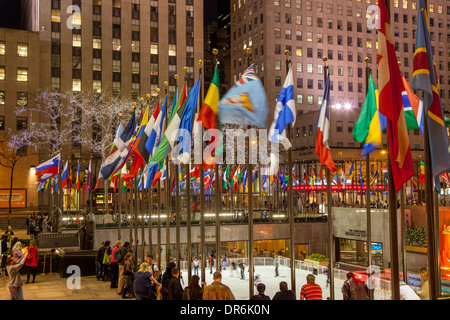 International flags surround the ice rink at Rockefeller Center, Manhattan, New York City, USA Stock Photo