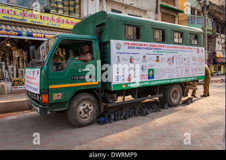 South Southern India Tamil Nadu Madurai street scene army truck lorry TB tuberculosis heath centre center boots left under Stock Photo