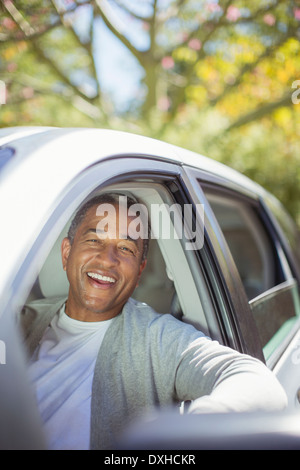 Portrait of senior man laughing in car Stock Photo