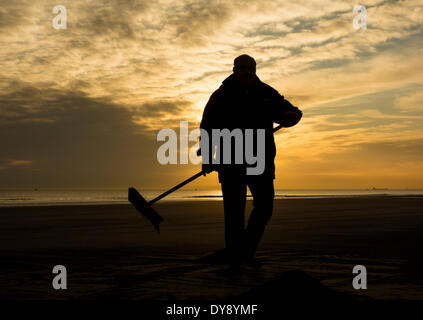 The Headland, Hartlepool, UK. 10th April, 2014. Seacoaler at sunrise on a glorious Thursday morning on the north east coast of England.  Washed up sea coal is gathered into piles and loaded onto a pick up truck to be later cleaned and sold on to power stations. Credit:  ALANDAWSONPHOTOGRAPHY/Alamy Live News Stock Photo