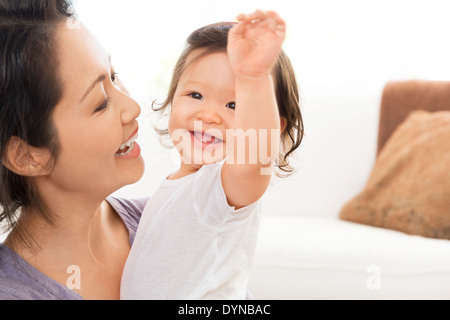 Mother playing with baby girl Stock Photo