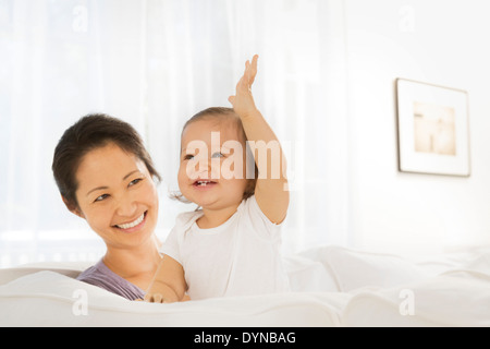 Mother and baby girl in living room Stock Photo