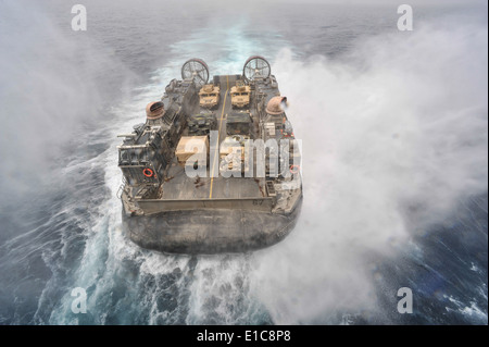 U.S. Navy Landing Craft, Air Cushion 67 approaches the well deck of the amphibious assault ship USS Bataan (LHD 5), not picture Stock Photo