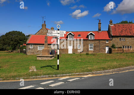 Goathland village green, road signs and war memorial, North Yorkshire, North York Moors National Park, England, UK. Stock Photo