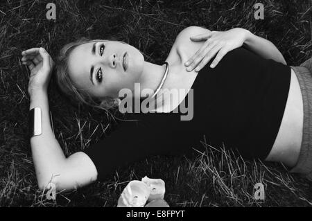 Woman lying in meadow Stock Photo