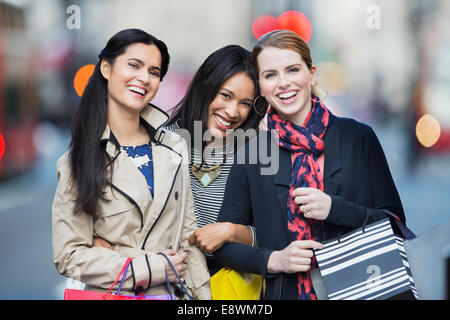 Friends walking down city street together Stock Photo