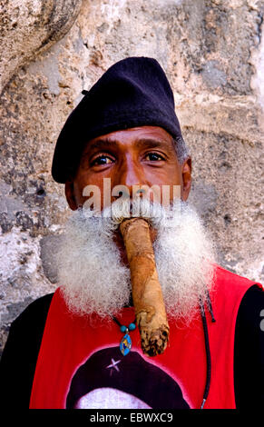 man with full beard and beret smoking a long cigar, Cuba, La Habana Stock Photo