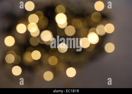 defocused bokeh from christmas decoration lights. shiny golden background Stock Photo