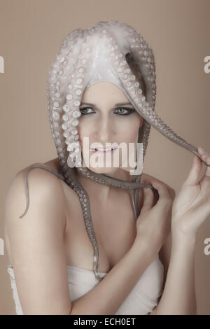 young woman with octopus on head Stock Photo