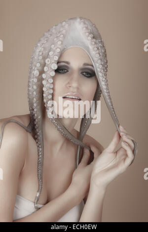 young woman with octopus on head Stock Photo