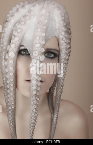 young woman with octopus on head Stock Photo