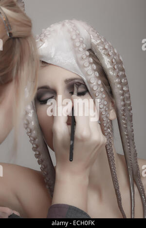 young woman with octopus on head Stock Photo